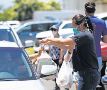 Help is on the Way Volunteer, Kimi Ide-Foster, Distributes Food to Seniors